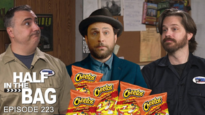 Mike and Jay are on opposite sides of the thumbnail, with lightly smiling expressions mimicking that of Charlie Day who is photoshopped into the center. Bags of Cheetos poke in from the bottom of the frame.
