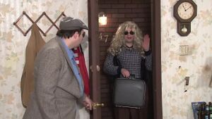 Mr. Plinkett stands by the doorway, next to his sister Harriet Plinkett. Both are obviously played by Rich Evans.